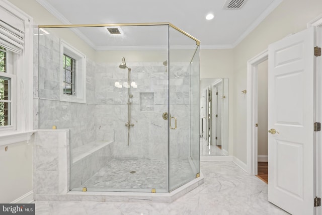 bathroom featuring a shower with door and crown molding