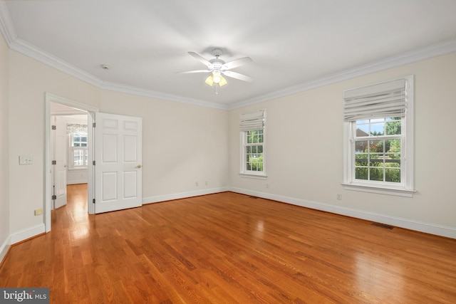 spare room with ornamental molding, wood-type flooring, and ceiling fan