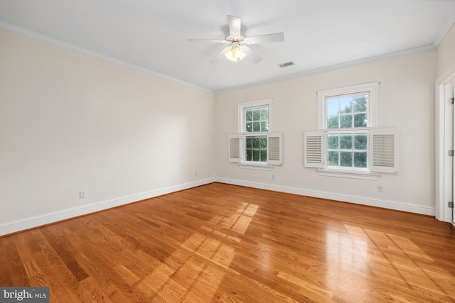 empty room featuring ceiling fan, ornamental molding, and light wood-type flooring