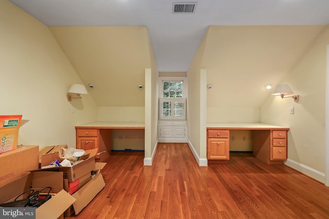 bathroom featuring lofted ceiling and hardwood / wood-style flooring