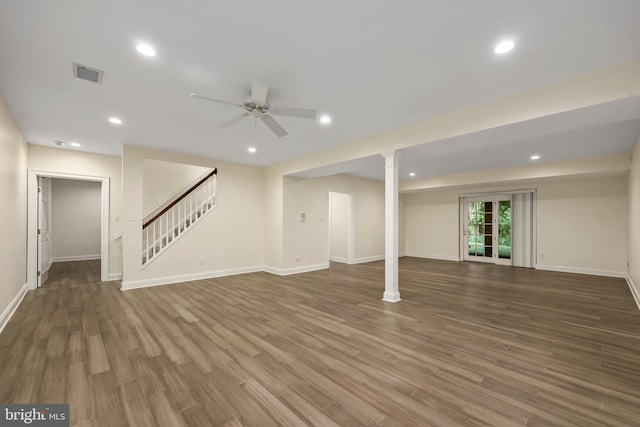 basement featuring ceiling fan and dark hardwood / wood-style flooring