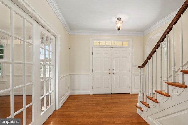 entryway with crown molding and wood-type flooring