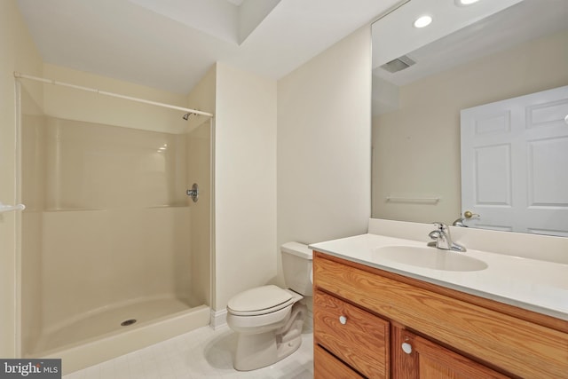 bathroom featuring vanity, toilet, and walk in shower