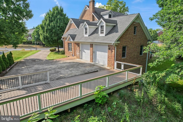 exterior space featuring a wooden deck and a garage