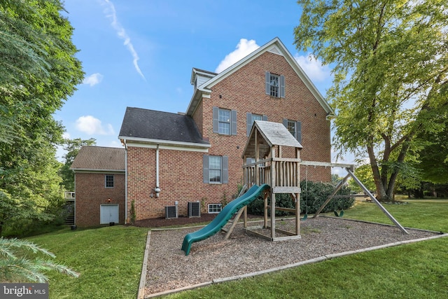 view of jungle gym with central AC and a yard