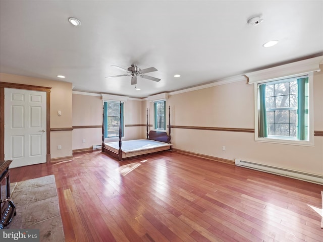 unfurnished bedroom with a baseboard radiator, crown molding, and light wood-type flooring