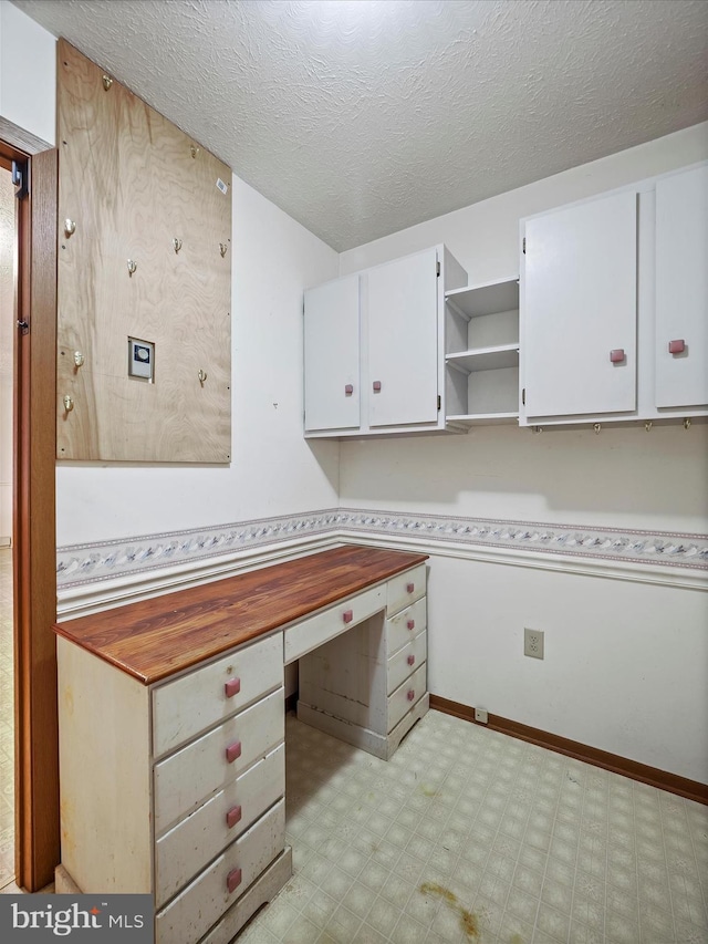 unfurnished office with a textured ceiling