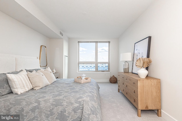 bedroom featuring light colored carpet