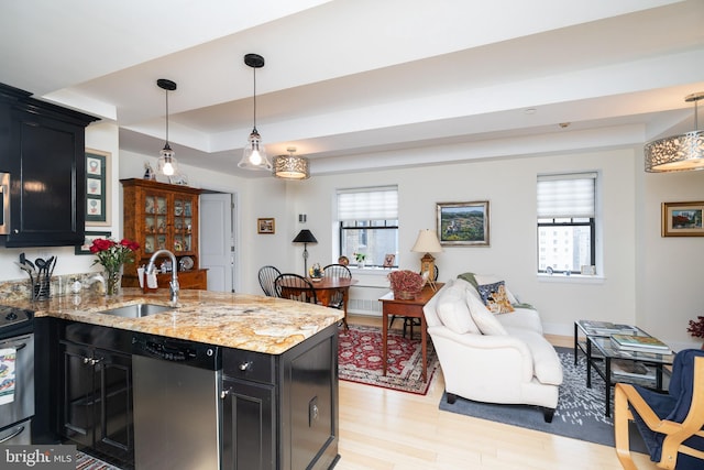 1701 Locust St Unit 1505, Philadelphia, PA 19103 - kitchen with stainless steel dishwasher, dark cabinetry, a sink, a peninsula, and a tray ceiling