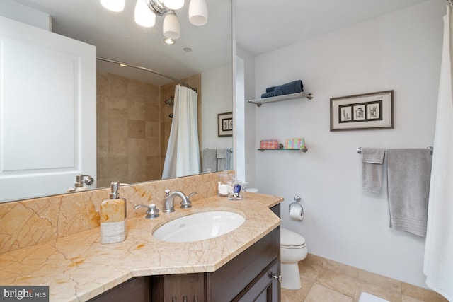 bathroom with vanity, a shower with shower curtain, toilet, and tile patterned flooring