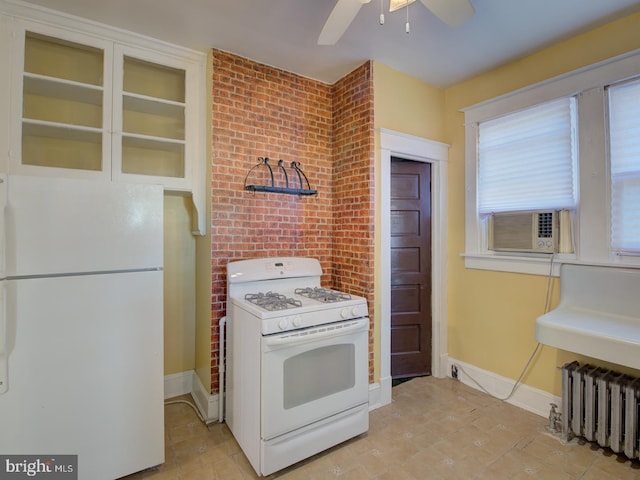 kitchen with brick wall, radiator, ceiling fan, white appliances, and cooling unit