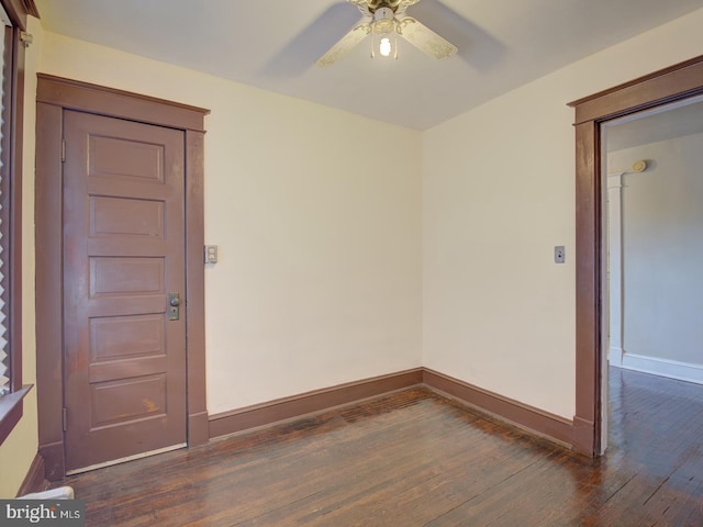 empty room with dark hardwood / wood-style flooring and ceiling fan