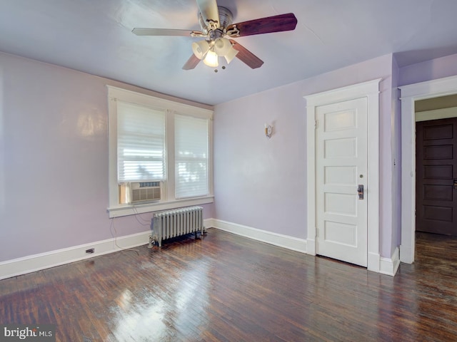 spare room with radiator, ceiling fan, cooling unit, and dark hardwood / wood-style floors