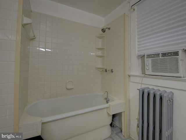 bathroom with tiled shower / bath, radiator heating unit, and cooling unit