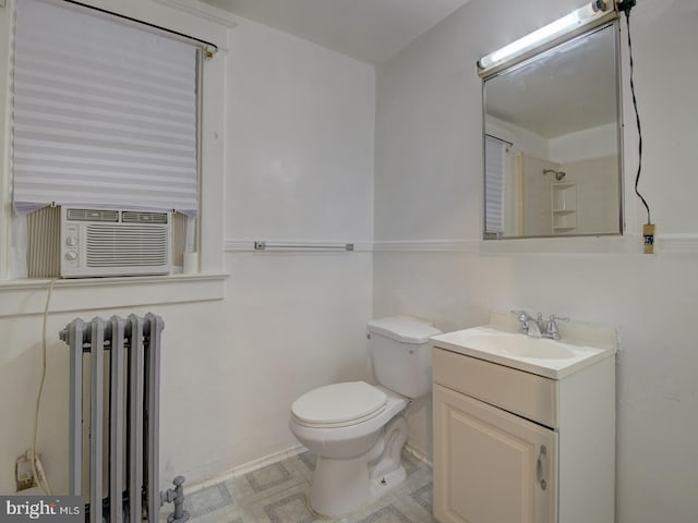 bathroom featuring toilet, radiator, vanity, and cooling unit