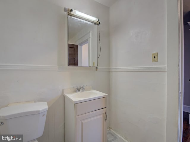 bathroom featuring vanity and toilet