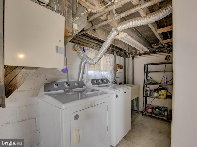 laundry area featuring washing machine and dryer and sink