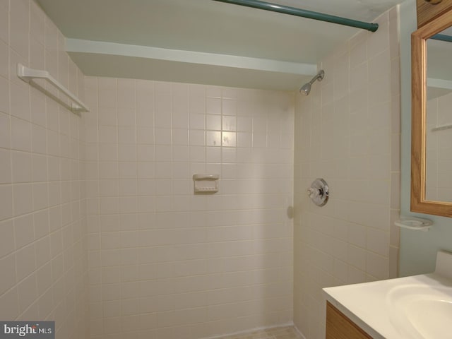 bathroom featuring vanity and tiled shower