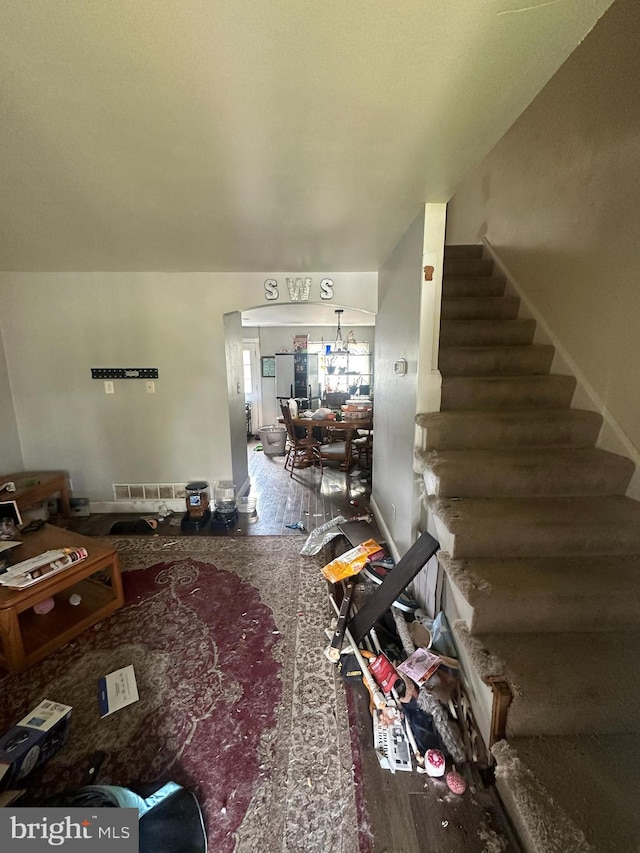 living room with a notable chandelier and hardwood / wood-style flooring