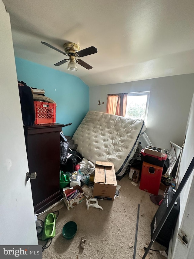 bedroom featuring ceiling fan, vaulted ceiling, and carpet floors