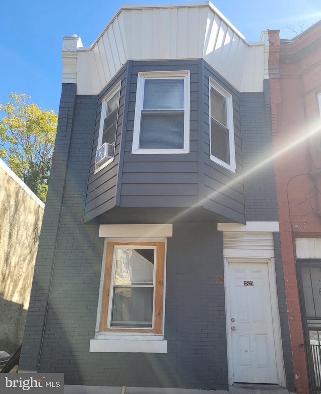 2835 N Ringgold St, Philadelphia, PA 19132 - view of side of home featuring cooling unit, brick siding, and board and batten siding
