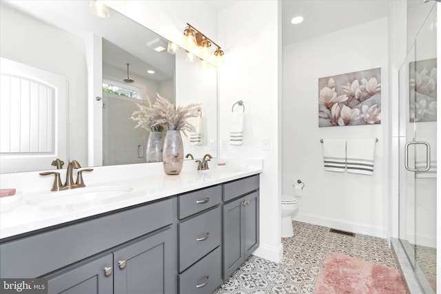 bathroom with vanity, an enclosed shower, and toilet