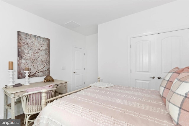 bedroom with a closet and hardwood / wood-style flooring