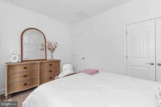 bedroom featuring hardwood / wood-style flooring and a closet