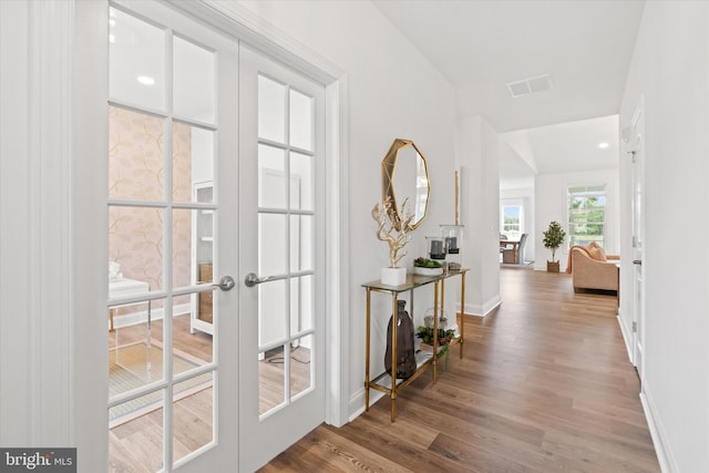 corridor featuring french doors and hardwood / wood-style floors