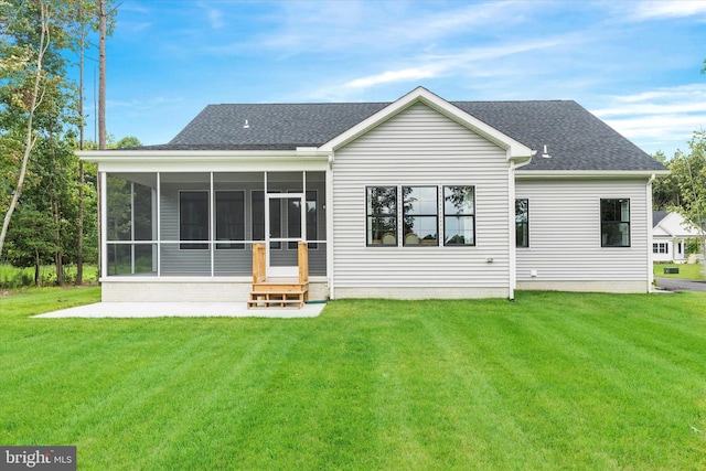 back of property featuring a lawn and a sunroom