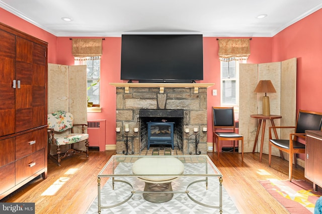 living room with light hardwood / wood-style floors and crown molding