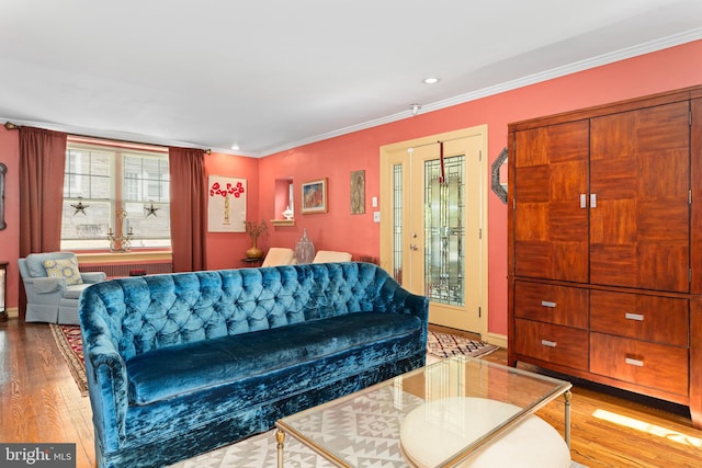 living room featuring crown molding and hardwood / wood-style flooring