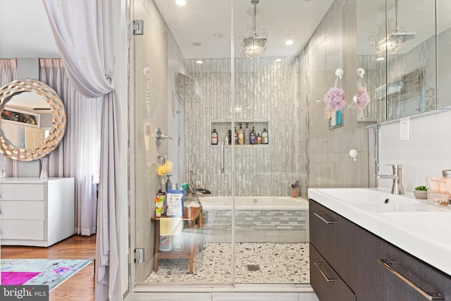 bathroom with vanity, independent shower and bath, and wood-type flooring