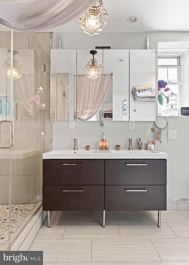 bathroom with vanity, a notable chandelier, and walk in shower