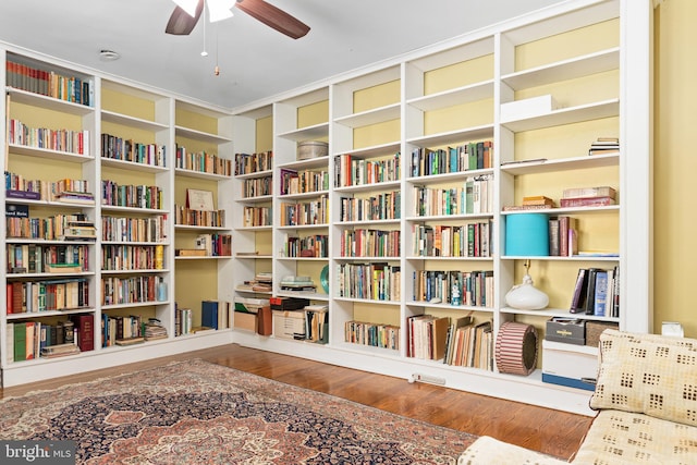 sitting room with hardwood / wood-style flooring