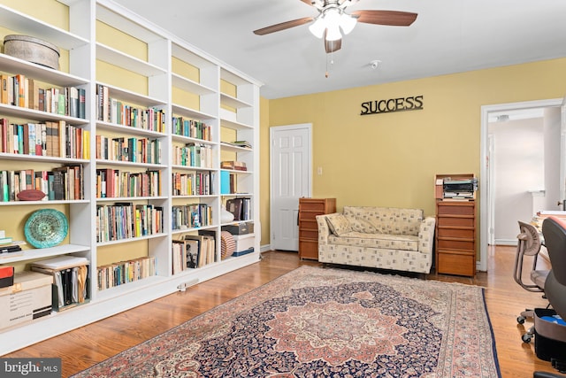 sitting room featuring light hardwood / wood-style floors and ceiling fan