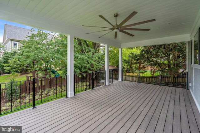 wooden deck featuring a playground and ceiling fan