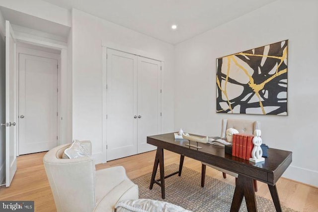 home office with light hardwood / wood-style floors