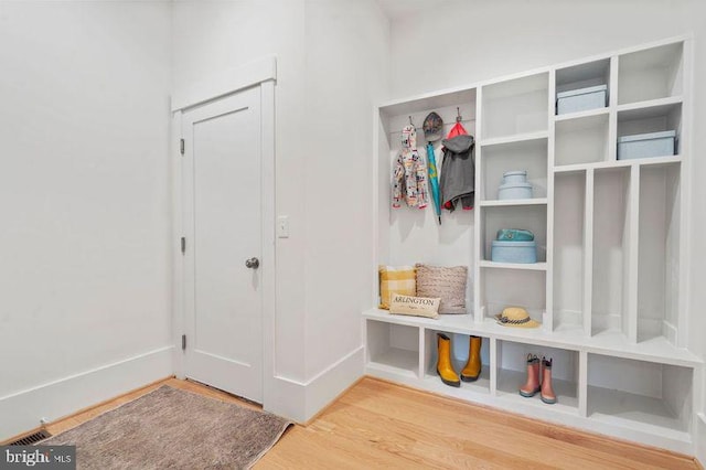 mudroom with visible vents, baseboards, and wood finished floors