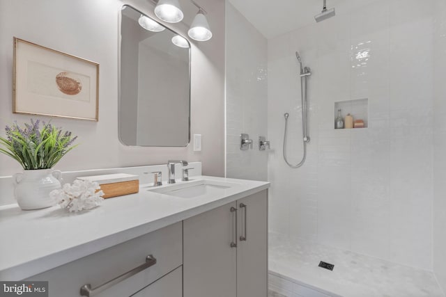 bathroom featuring vanity and a tile shower