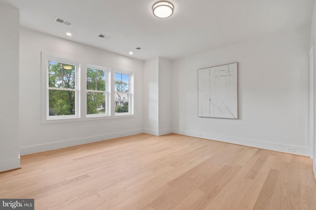 spare room featuring light hardwood / wood-style floors