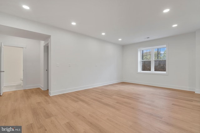 unfurnished room with light wood finished floors, recessed lighting, and baseboards