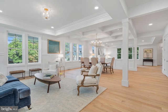 living room featuring light wood-type flooring, coffered ceiling, beam ceiling, ornamental molding, and a chandelier