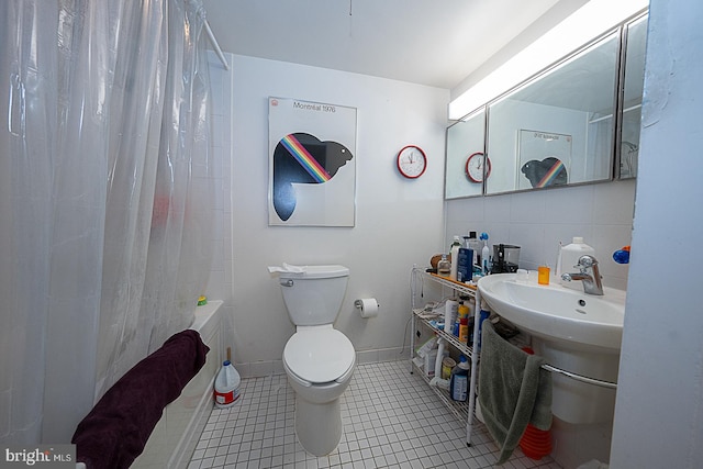 bathroom with tasteful backsplash, shower / bath combination with curtain, tile walls, toilet, and tile patterned floors