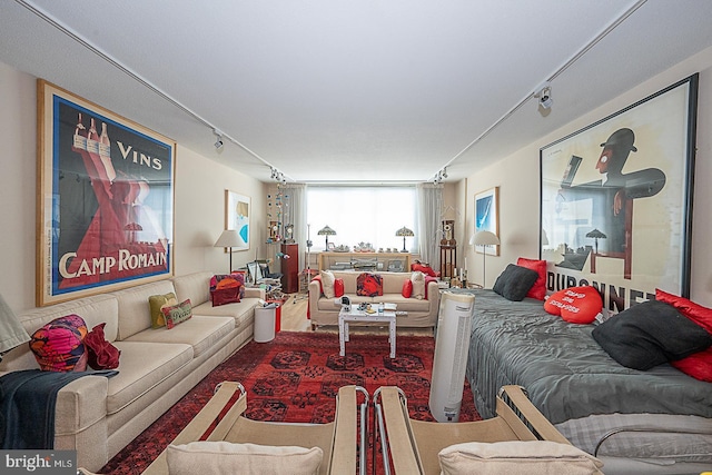 living area featuring track lighting and carpet floors