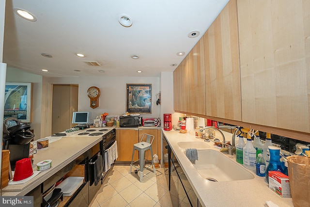 kitchen with light tile patterned flooring, sink, and light brown cabinets