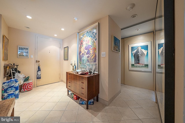 hallway with light tile patterned floors and recessed lighting