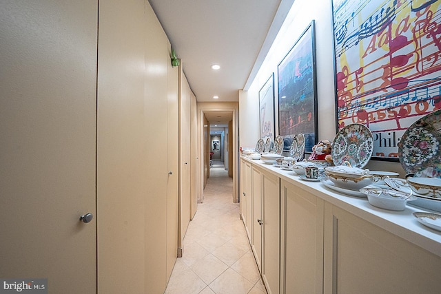 hall with light tile patterned floors and recessed lighting