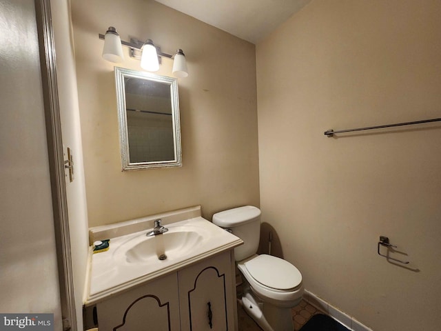 bathroom with vanity, toilet, and tile patterned flooring