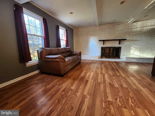 living room with crown molding, hardwood / wood-style flooring, and beamed ceiling